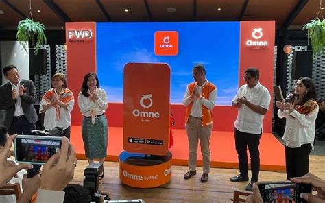 The Omne by FWD launch event, with the product team on stage beside a branded booth